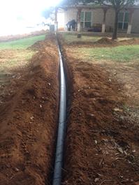Drainage from downspouts install before landscape and/or sidewalks