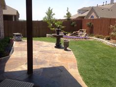After complete the new flagstone patio, waterfall, stone border and landscape construction